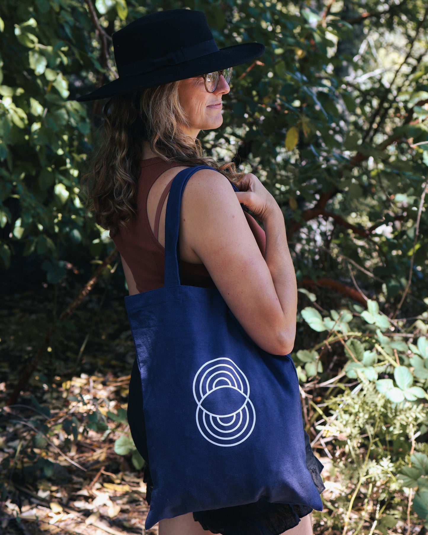 Woman carrying the 100% organic cotton, navy flat tote bag