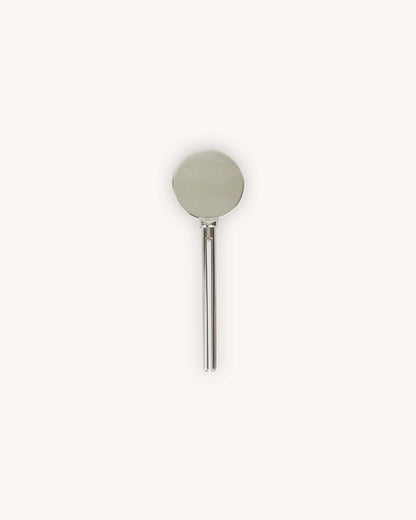 A minimalist zinc alloy METAL tube key featuring a circular disc head and a slim vertical prong pin design to slip aluminum tube into.